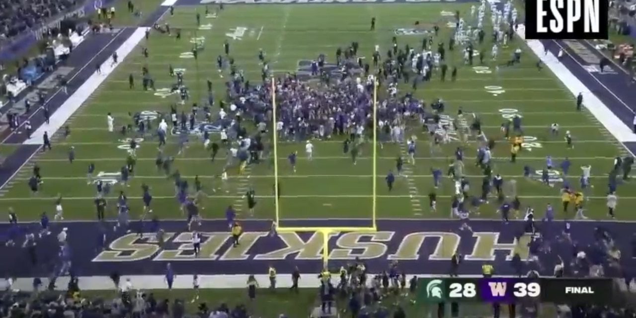 Washington fans storm the field after upsetting No. 11 Michigan State
